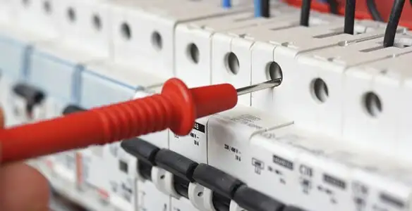 Electrical contractor testing circuit breakers during electrical repair in De Pere, WI