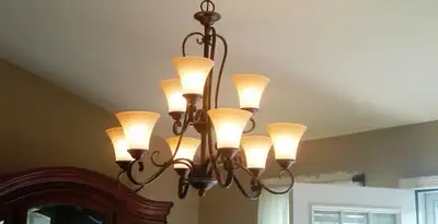 Classic ceiling chandelier installation with warm lighting in Green Bay, WI