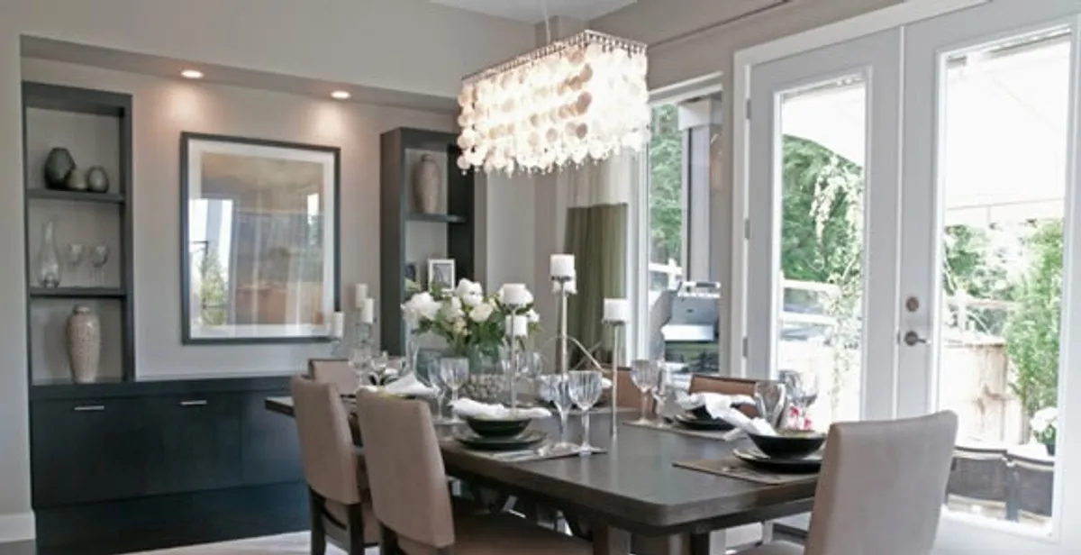 Elegant dining room chandelier installation above table in Green Bay, WI