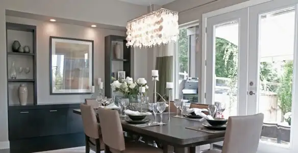 Elegant dining room chandelier installation above table in Green Bay, WI