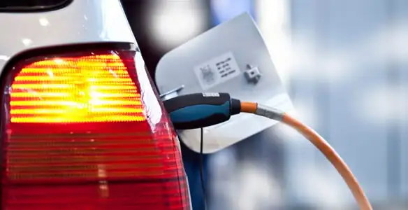 Electric car plugged into EV charger after professional installation in Green Bay, WI