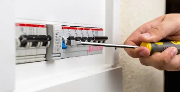 electrical panel upgrade service showing technician adjusting circuit breakers during system upgrade in Green Bay, WI