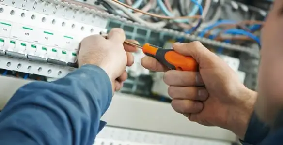 electrical service showing licensed electrician performing electrical panel maintenance and adjustments in Green Bay, WI