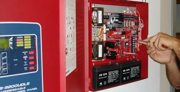 fire alarm installation service showing technician configuring fire alarm control panel in Green Bay, WI