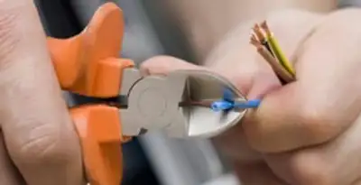 professional electrical services showing precise wire cutting by licensed electricians in Green Bay, WI