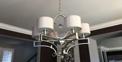 Modern chandelier installation with multiple light fixtures in Green Bay, WI