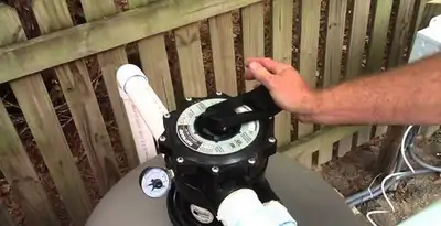 pool pumps service showing professional adjustment of pool pump control system in Green Bay, WI