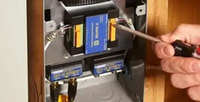 Whole home surge protection device being installed by a licensed electrician to protect electrical systems in Green Bay, WI